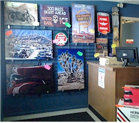 a good selection of office or man cave garage art classics hot rods road signs gas pumps stools and more